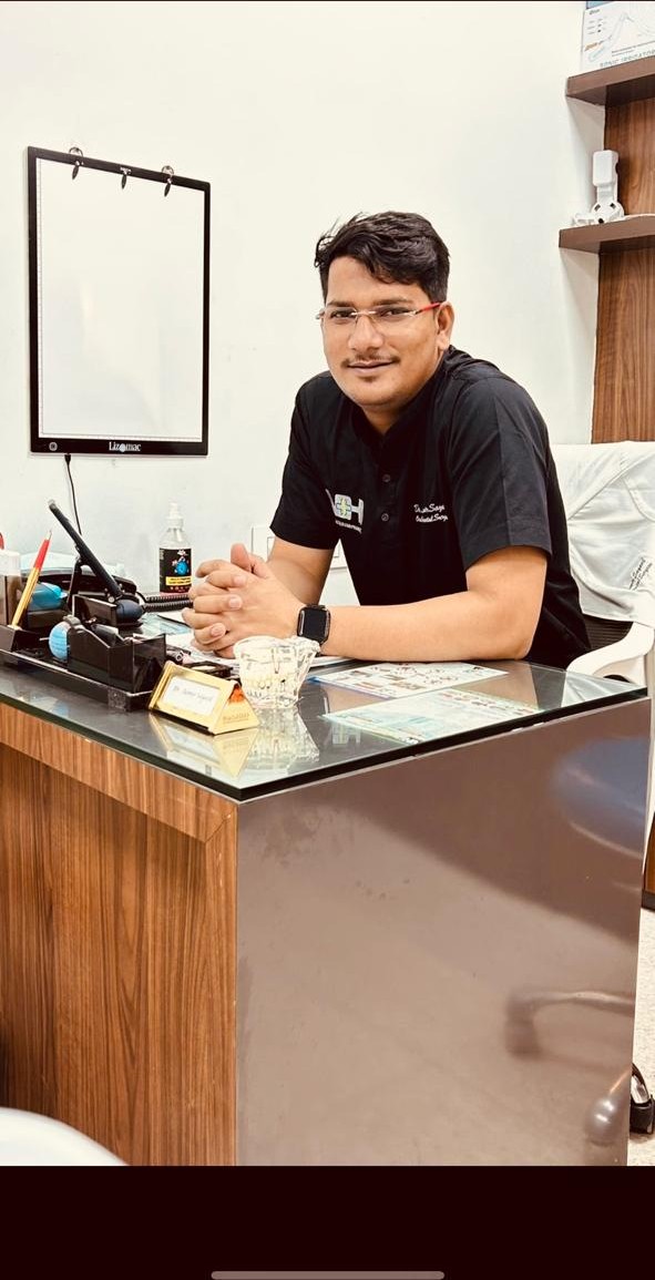 Dentist at Niyaz Dental Unit seated at the clinic consultation desk